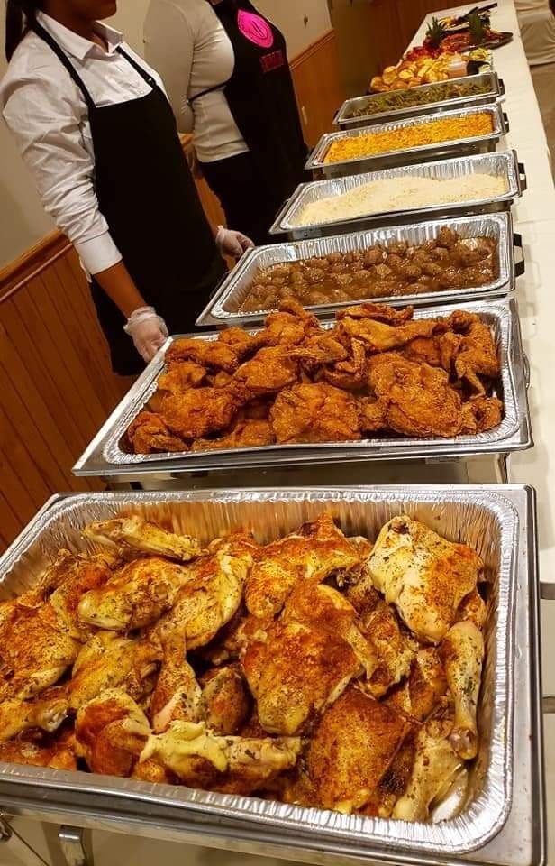 A buffet comprising a variety of foods and a cook ready to serve the food